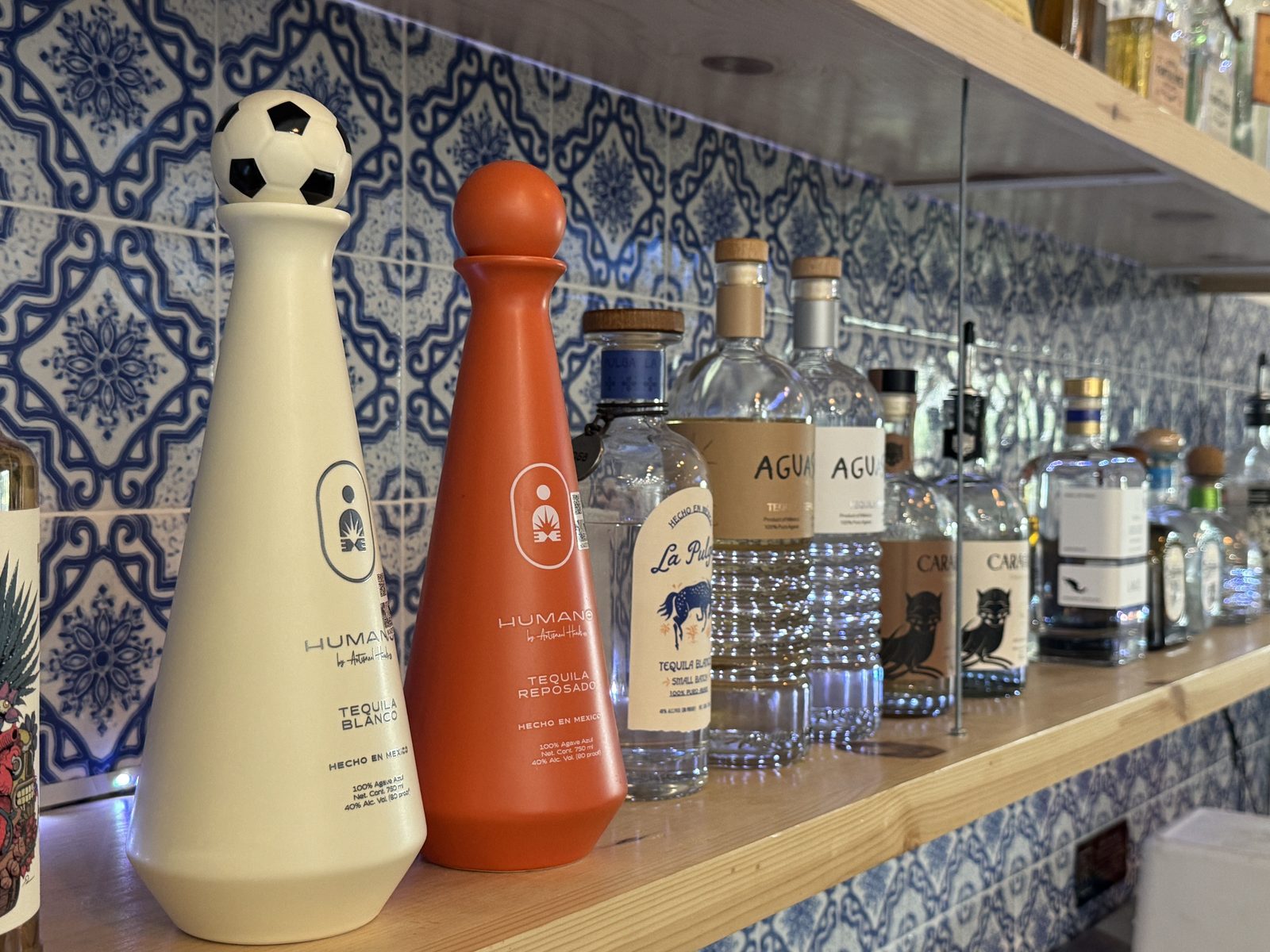 Bottles lined up along the tiled Courtside Cantina back bar